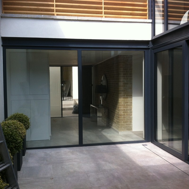 Floor-to-ceiling sliding doors opening to courtyard in Lower Edmonton