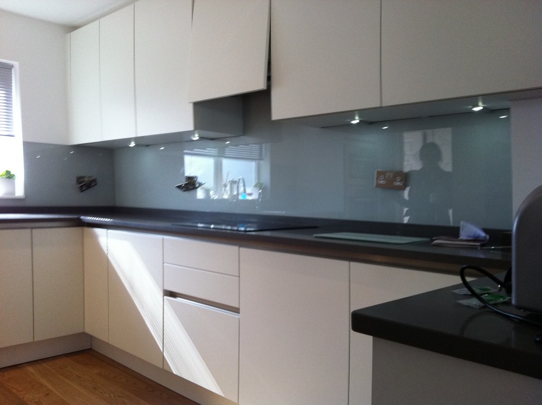 Grey glass kitchen splashback with LED lighting in Lower Edmonton