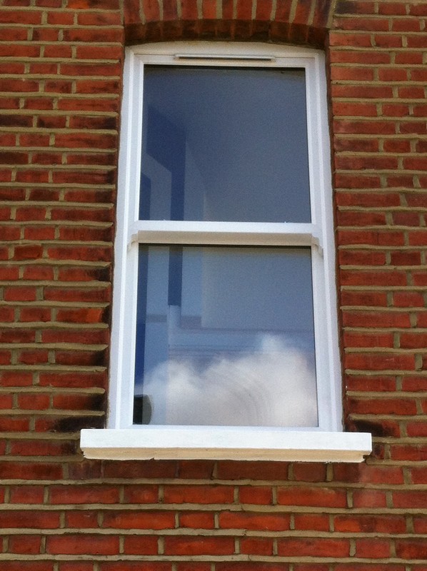 uPVC sash window on Victorian red brick house in Lower Edmonton